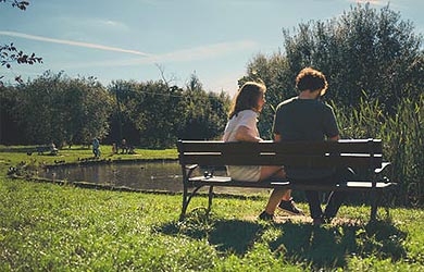 Couple sitting by river